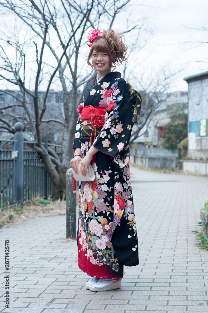 Japanese girl posing for the pictures of the Coming of Age Day. In Japan, people celebrate their 20s of a year as becoming adults wearing Japanese tradition dress. Japanese girl posing for the pictures of the Coming of Age Day. In Japan, people celebrate their 20s of a year as becoming adults wearing Japanese tradition dress.