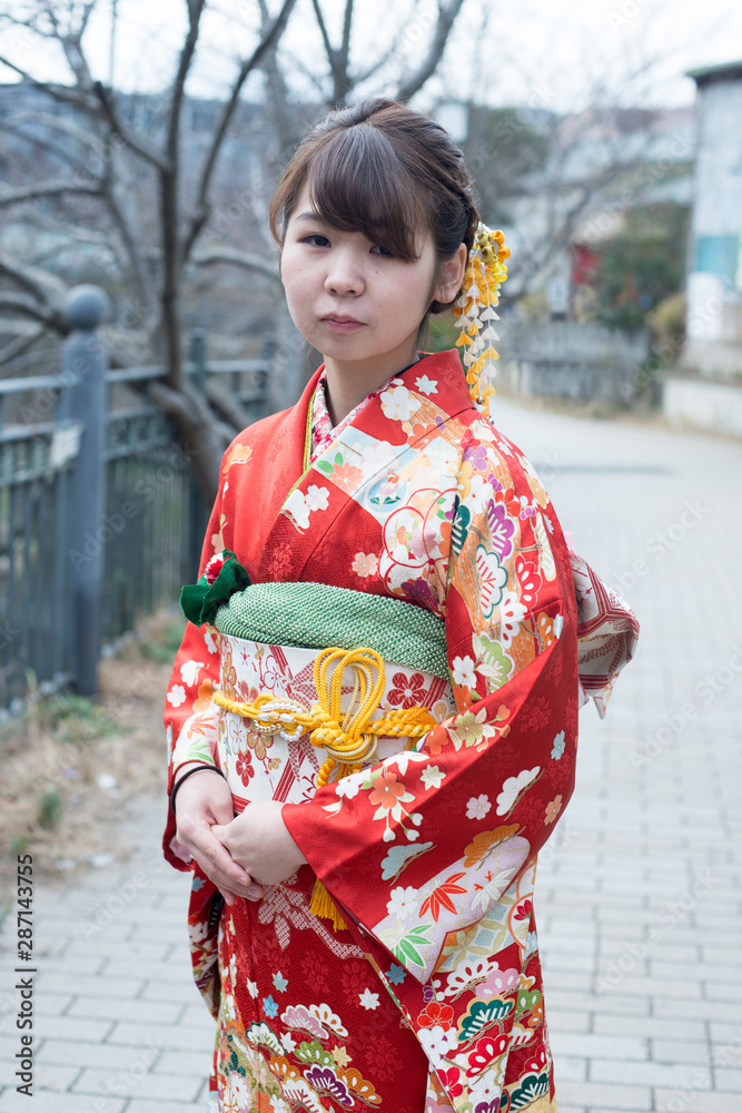 Japanese girl posing for the pictures of the Coming of Age Day. In Japan, people celebrate their 20s of a year as becoming adults wearing Japanese tradition dress. Japanese girl posing for the pictures of the Coming of Age Day. In Japan, people celebrate their 20s of a year as becoming adults wearing Japanese tradition dress.