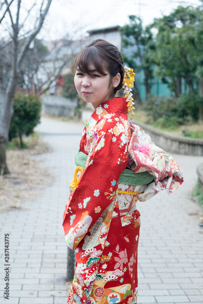 Japanese girl posing for the pictures of the Coming of Age Day. In Japan, people celebrate their 20s of a year as becoming adults wearing Japanese tradition dress.