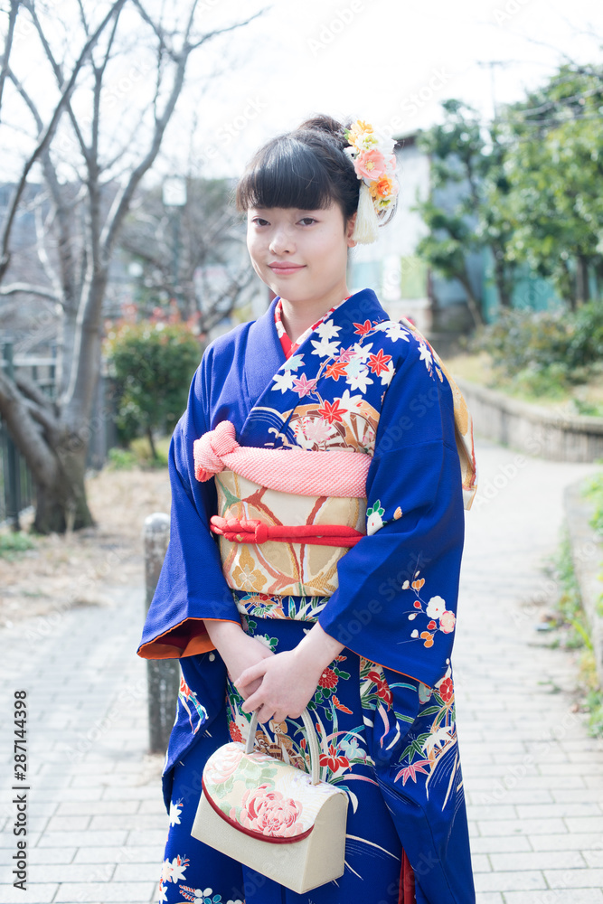 Japanese girl posing for the pictures of the Coming of Age Day. In Japan, people celebrate their 20s of a year as becoming adults wearing Japanese tradition dress. Japanese girl posing for the pictures of the Coming of Age Day. In Japan, people celebrate their 20s of a year as becoming adults wearing Japanese tradition dress.