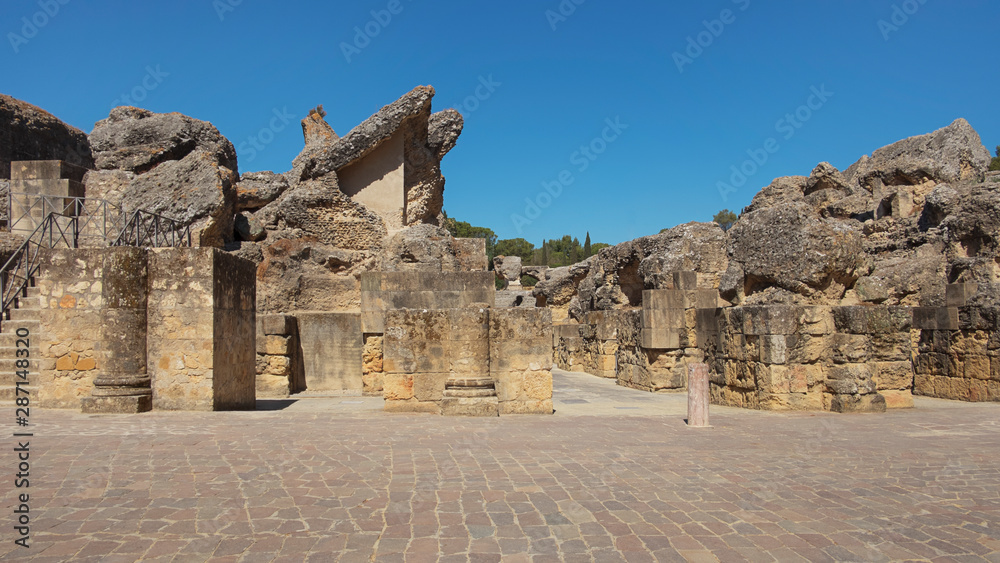 Fototapeta premium Ruins of the splendid amphitheater, part of archaeological ensemble of Italica, city with a strategic role in the Roman Empire, birthplace of Emperors Trajan and Hadrian, in Santiponce, Seville, Spain
