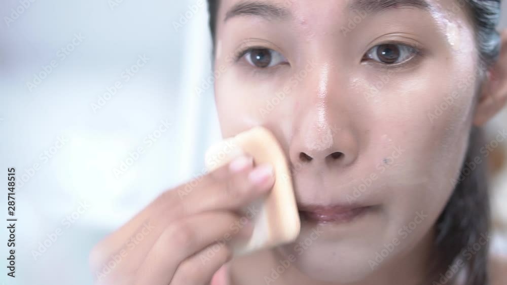 Woman applying foundation for face before make-up.