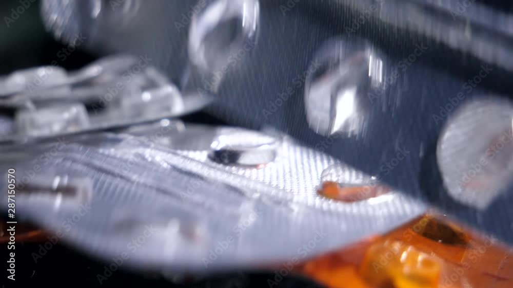 Empty pill packs slow motion fall close up Empty pill packs slow motion fall close up