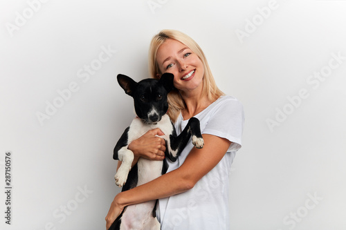 happy young beautiful woman hugging her favourite pet Friendship between people and animals, isolated white background, studio shot, love, tender, warm feeling and emotion