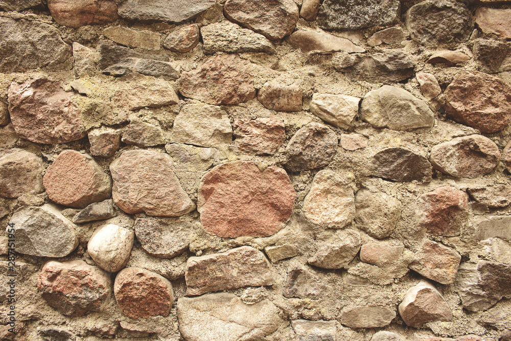 Old brown textured aged stone wall background Old brown textured aged stone wall background