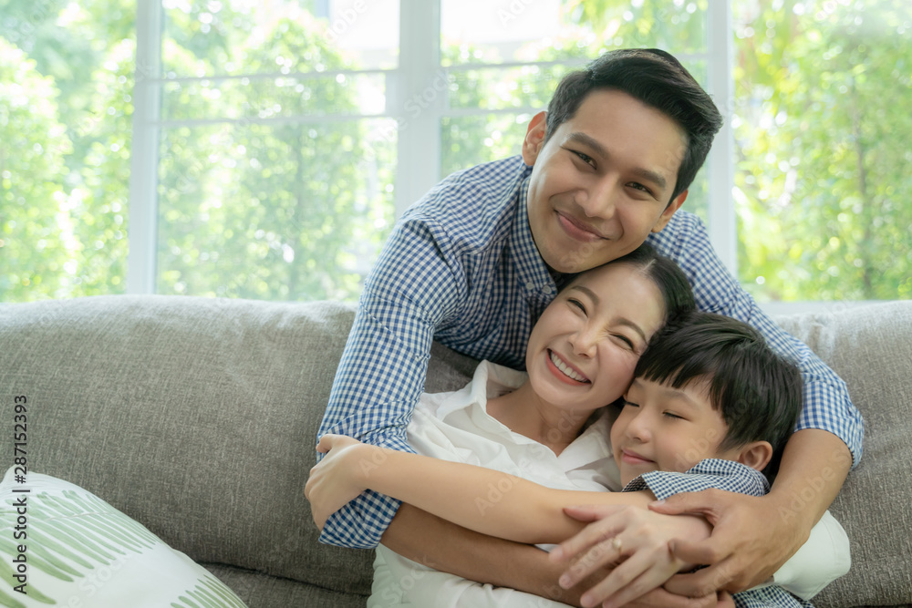 happy asian family spending time together on sofa in living room. family and home concept happy asian family spending time together on sofa in living room. family and home concept