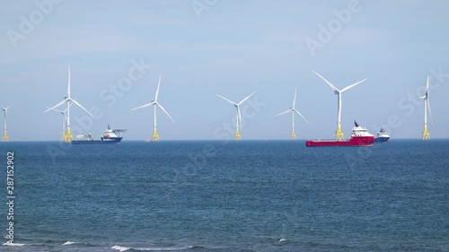 Sea wind farm turbines and ships in Aberdeen, renewable energy. Scotland