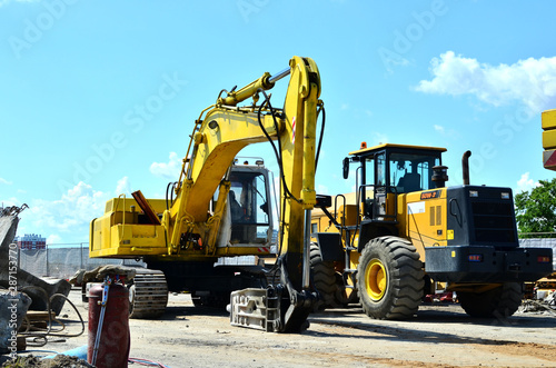 Crawler excavator with hydraulic hammer for the destruction of concrete and hard rock at the construction site.