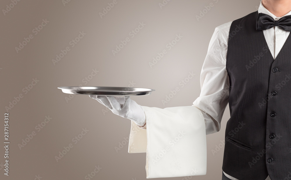 Waiter serving with white gloves and steel tray in an empty space