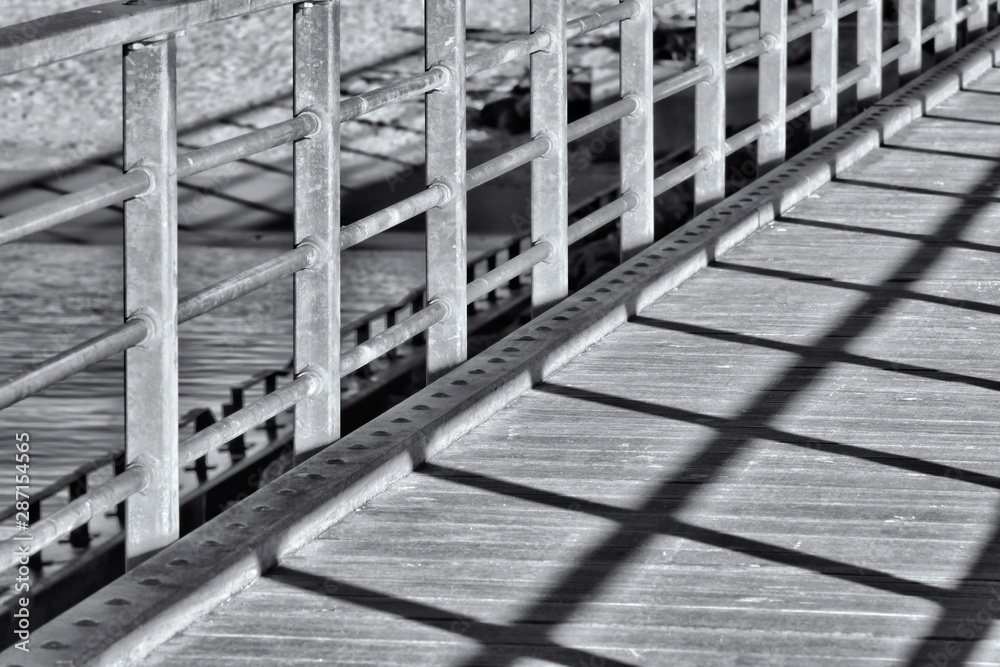 A close up of a bridge with shadow in black and white