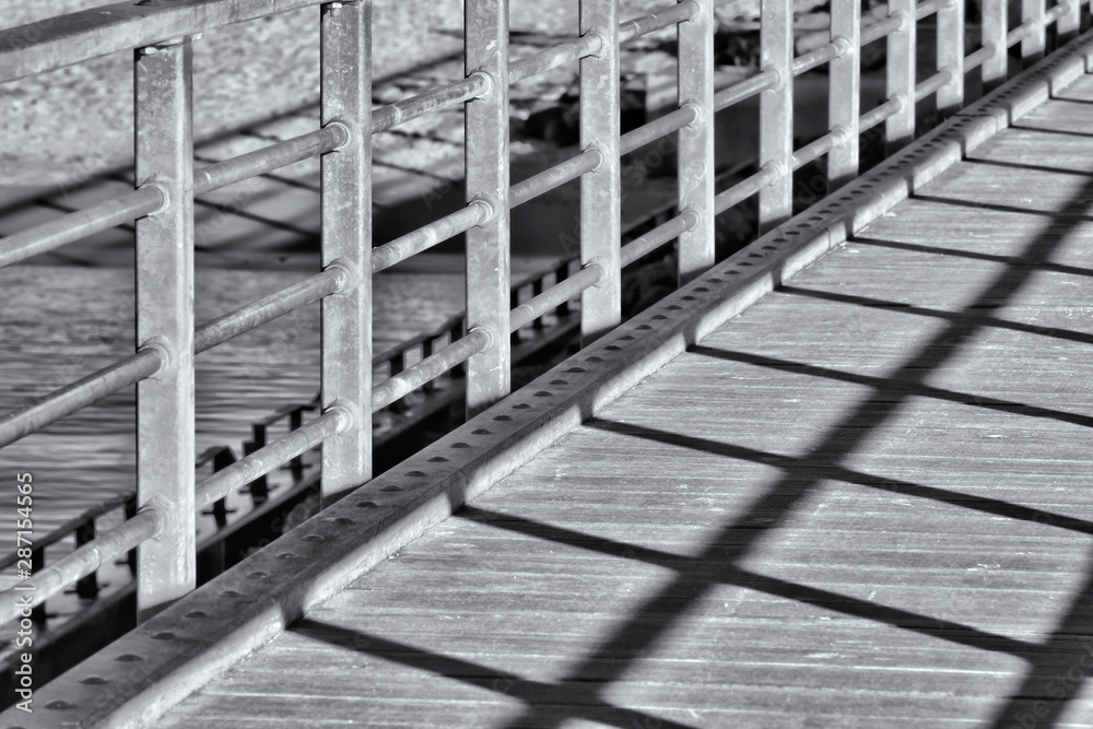 A close up of a bridge with shadow in black and white A close up of a bridge with shadow in black and white