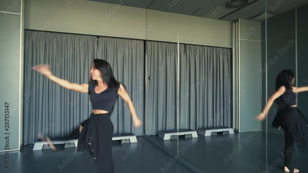 Russian girl is cool dancing in the studio. She is wearing long black knee-high socks and a black tank top. Russian girl is cool dancing in the studio. She is wearing long black knee-high socks and a black tank top.