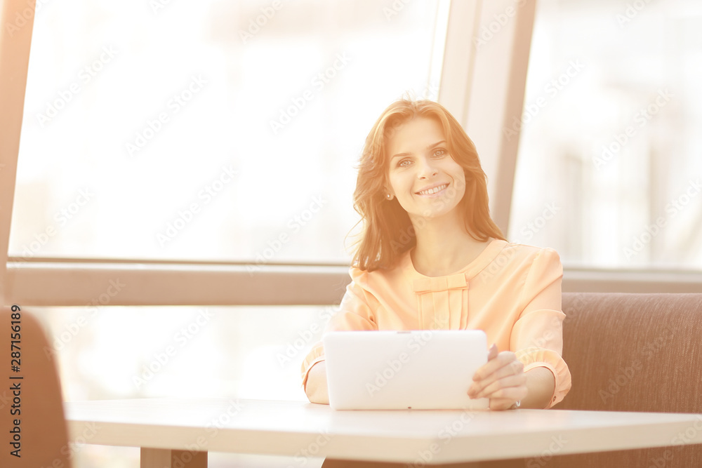 woman consultant using a digital tablet in the workplace in the office woman consultant using a digital tablet in the workplace in the office