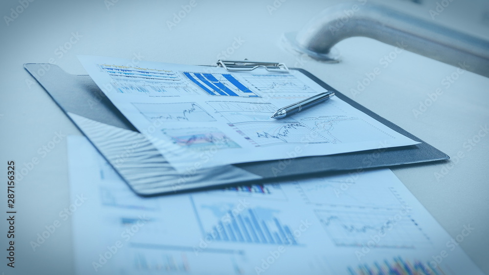 pen and financial documents on the desktop in the office pen and financial documents on the desktop in the office