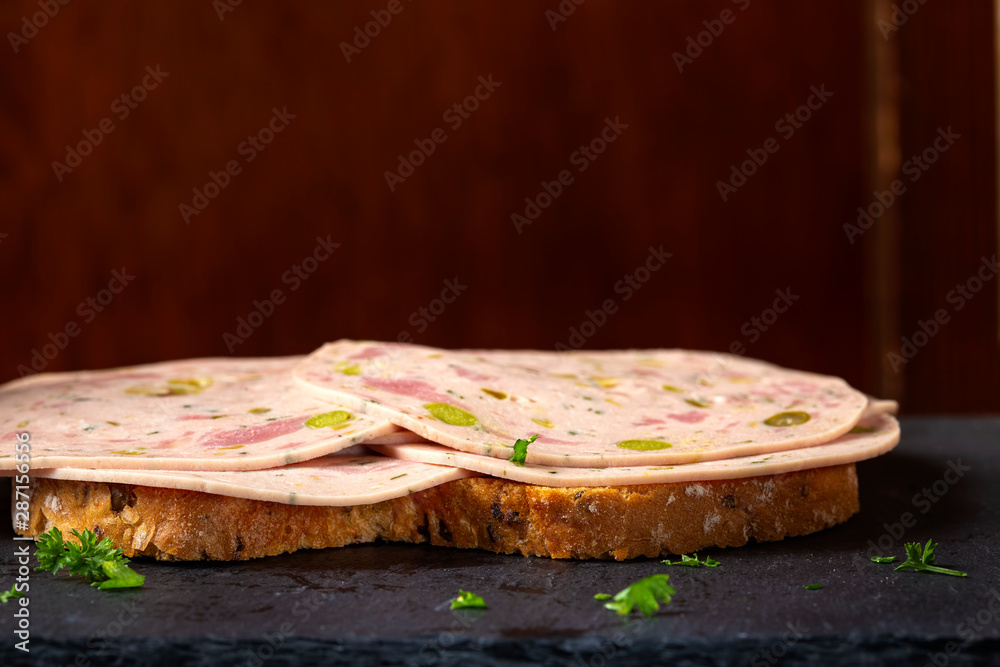 Open sandwich with Salami made from green vegetables like olives and pepper