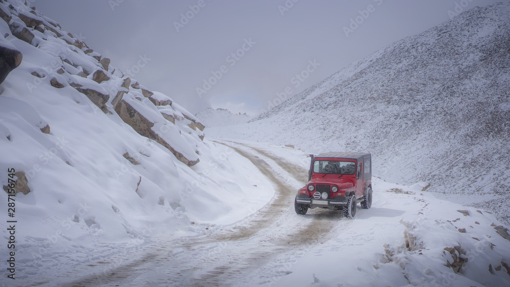 Red car on a snowy mountain Red car on a snowy mountain