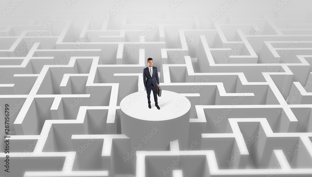 Businessman standing on the top a maze and looking through Businessman standing on the top a maze and looking through
