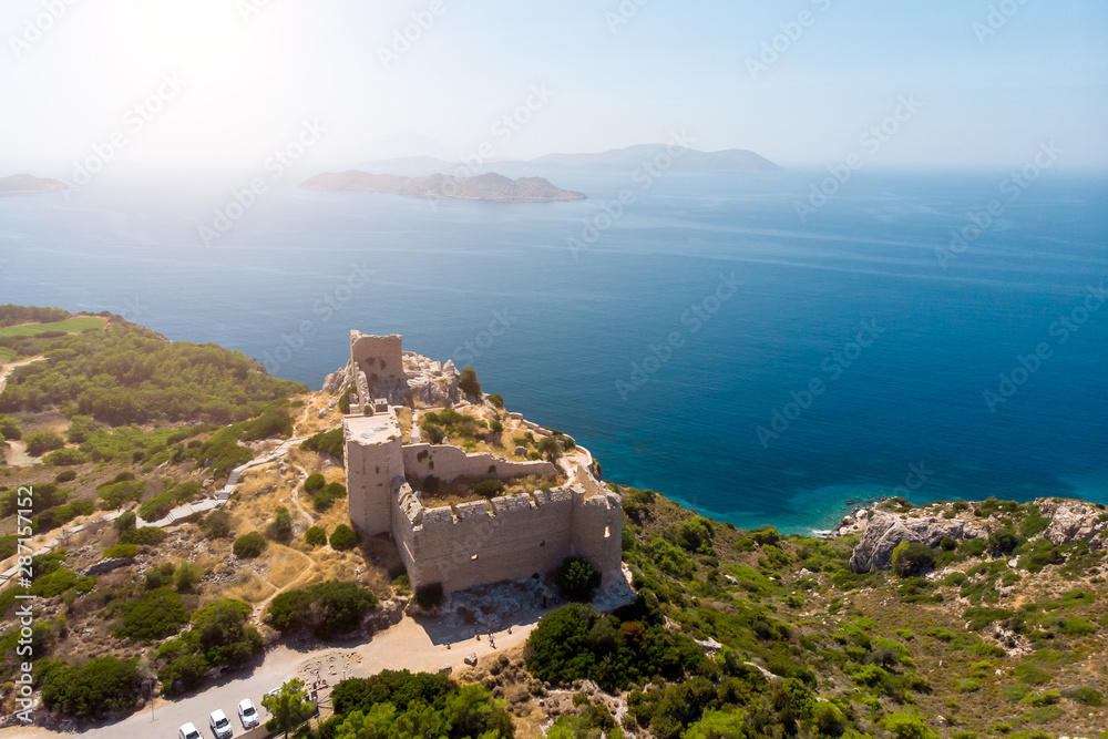 Photo of ancient fortress, sea, blue clear sky, mountain fortress.