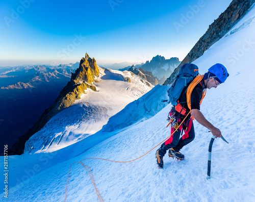 Fotótapéta Alpinist mountaineer climbing snow ice mountain slope.