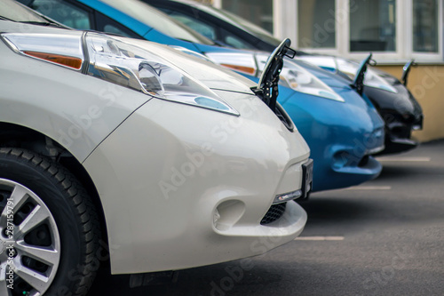 Three electric vehicles waiting in line for charging  Wahite car is in focus © Павел Печёнкин