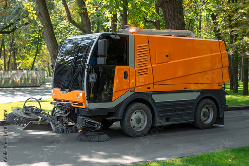 Urban cleaning process. Special vehicle washes city street or park. Ecology and pure air in modern megalopolis concept. Technology of municipal services