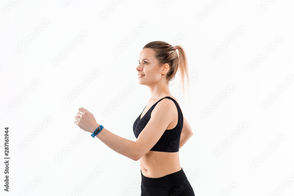 Young sporty blond woman in a black sportswear running isolated over white background. Young sporty blond woman in a black sportswear running isolated over white background.