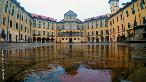 Medieval feudal castle. The courtyard of the castle is paved with cobblestones. It is raining.