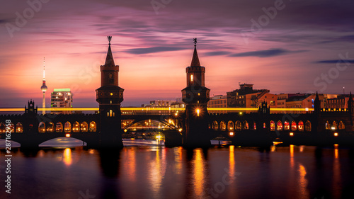 Beautiful sunset view at the Oberbaum Bridge in Berlin with the famous Television Tower in the back photo
