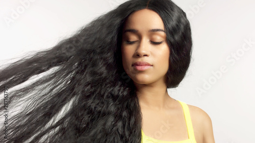 Fotografie, Obraz beauty mixed race african american model in studio portraits with long hair wig