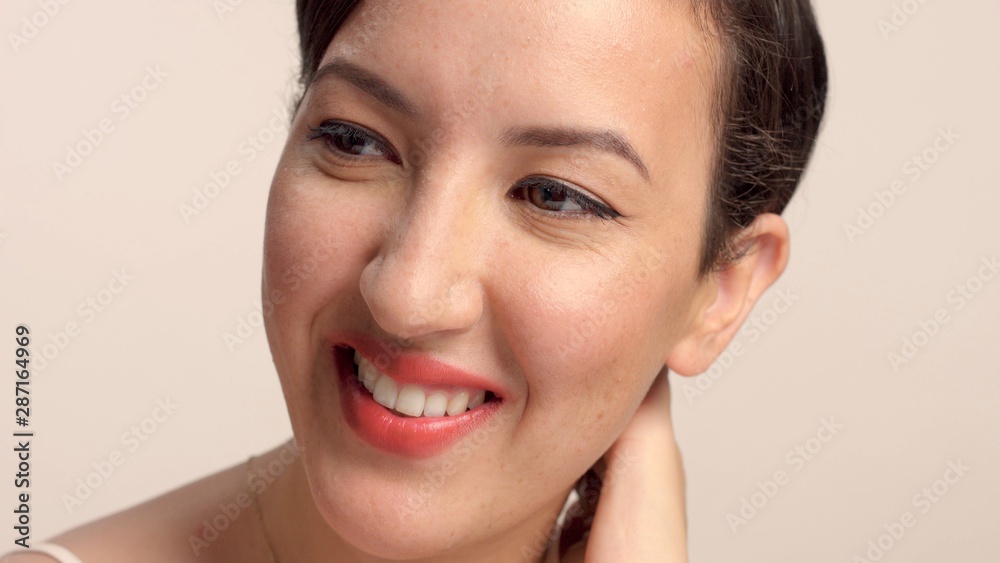 beauty brunette with short haircut model in studio alone with ideal shiny skin closeup portrait watching aside and smiling wide beauty brunette with short haircut model in studio alone with ideal shiny skin closeup portrait watching aside and smiling wide
