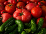 Fresh red tomatoes and green cucumbers, new vegetable harvest
