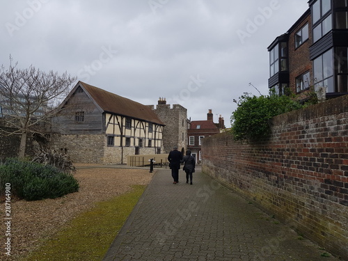 A A married couple walking by old cottages in England