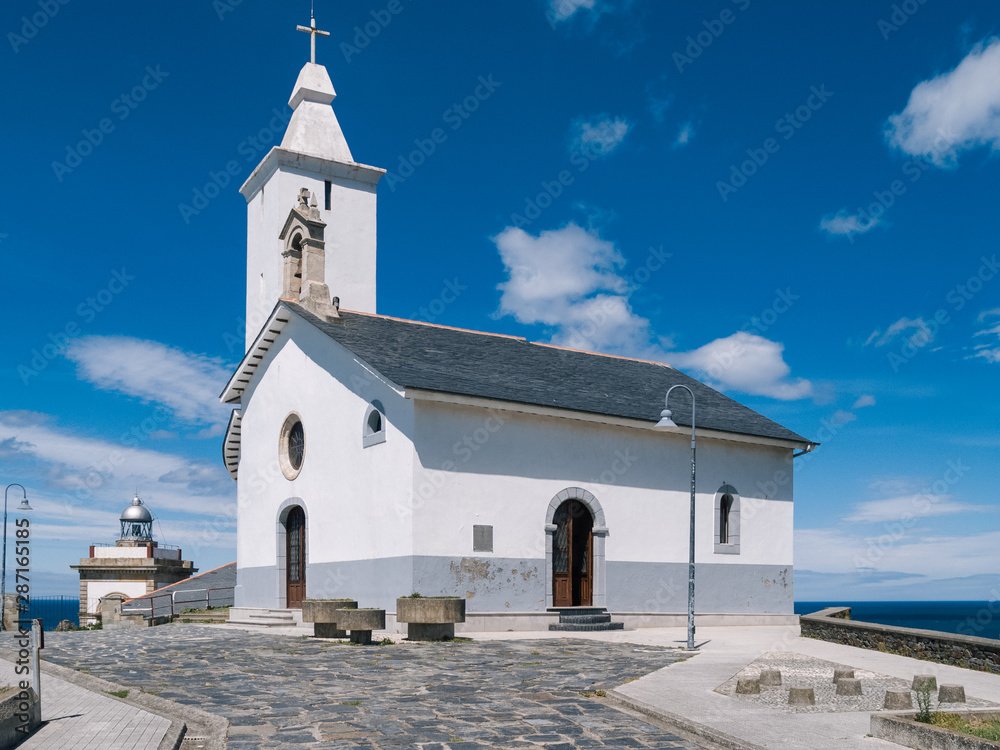 Obraz premium White hermitage in coastal town.