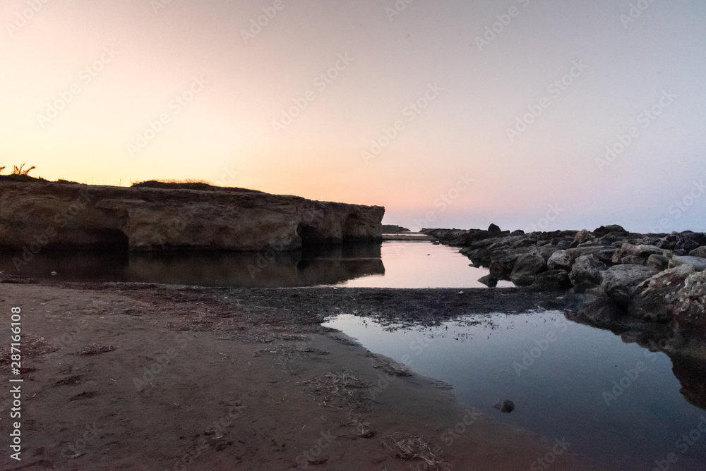 Shot of the Cirica Bay at sunrise. Cirica is a beautiful nature seaside place made of cliffs, rocks and sand in the southern Sicily, Italy	