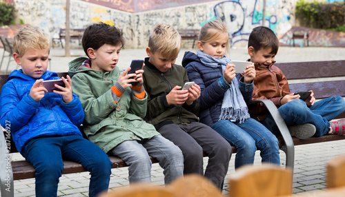 Children with phone outdoors