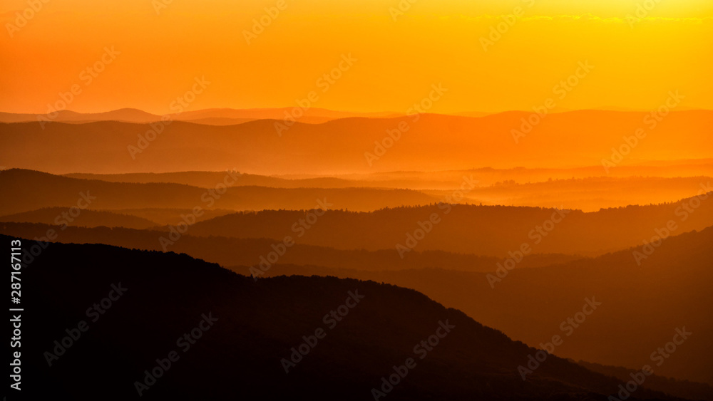 Silhouettes of the mountains at sunrise. Bieszczady National Park. Poland