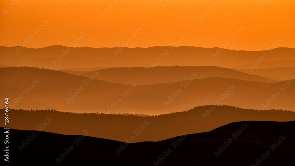 Silhouettes of the mountains at sunrise. Bieszczady National Park. Poland