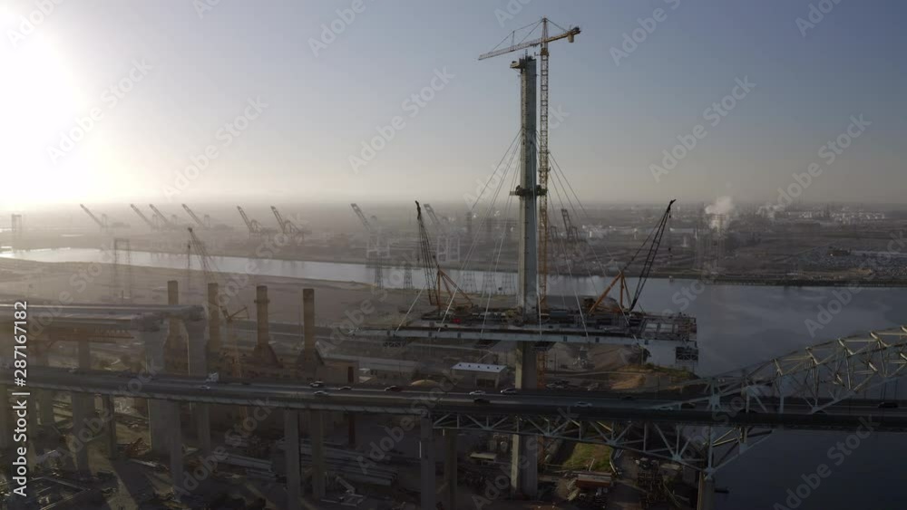 Aerial Pan: Steel Bridge with Fast Moving Traffic in Port of Los Angeles on Sunny Day - San Pedro, California