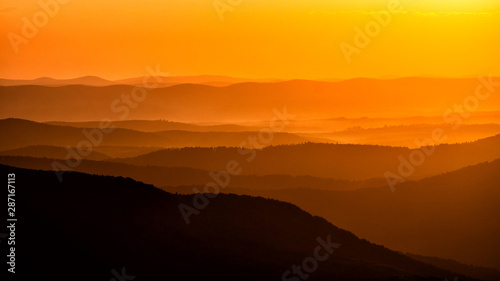 Silhouettes of the mountains at sunrise. Bieszczady National Park. Poland