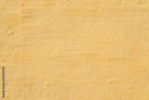 background of yellow brick wall is covered plaster 