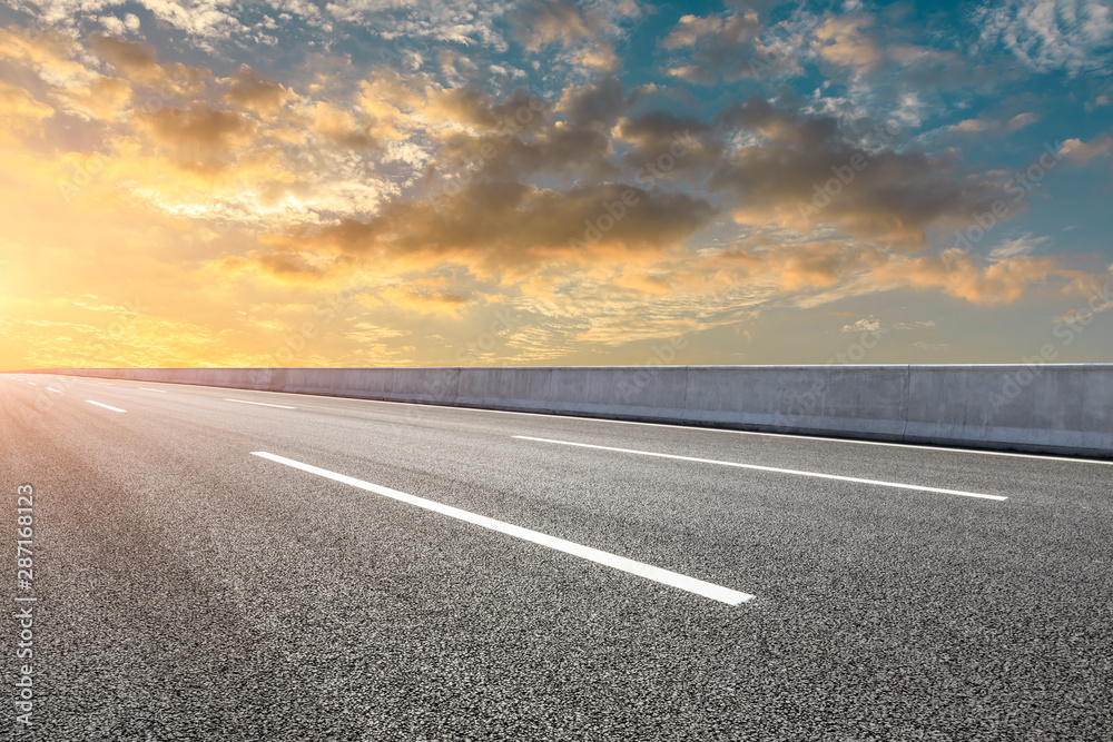 Empty asphalt highway and beautiful sky clouds at sunset