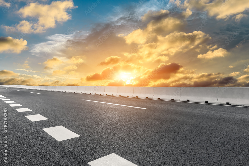 Empty asphalt highway and beautiful sky clouds at sunset Empty asphalt highway and beautiful sky clouds at sunset