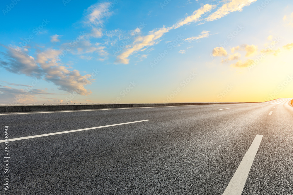 Empty asphalt highway and beautiful sky clouds at sunset