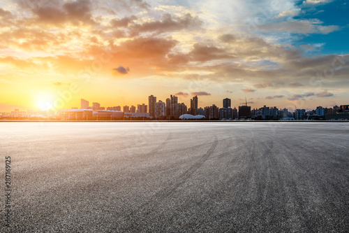 Asphalt race track and city skyline at sunset in Shanghai,China.