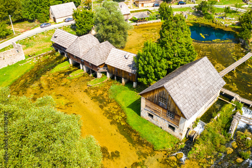 Croatia, countryside region of Lika, Majerovo vrilo river source of Gacka and old wooden mills and cottages aerial drone view photo