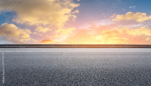 Empty asphalt highway and beautiful sky clouds at sunset