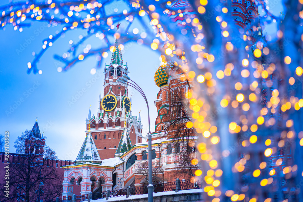 Christmas Moscow. Russia. Spasskaya tower. St. Basil's Cathedral. Panorama of Moscow. Illumination against the backdrop of the Kremlin. Christmas decorations on the streets of Moscow. New Year - obrazy, fototapety, plakaty 