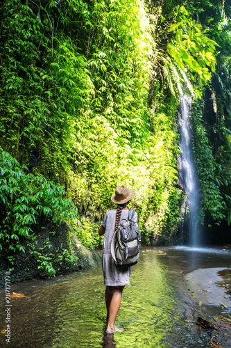 Woman near waterfal on Bali, Indonesia 