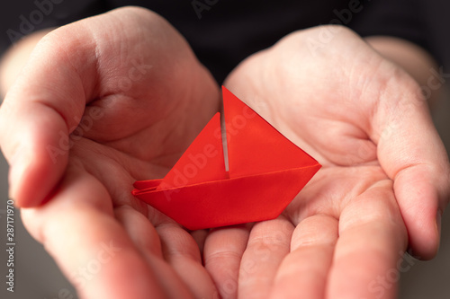 Small scarlet paper boat on...