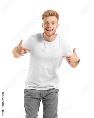 Man pointing at his t-shirt against white background